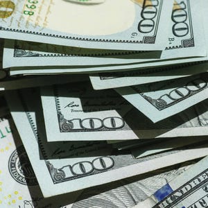 May include: Close-up of a stack of United States one hundred dollar bills. The bills are light blue and white with black and green details. The text "ONE HUNDRED DOLLARS" is visible on the bills.
