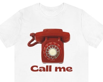 May include: White t-shirt with a red rotary phone graphic and the text "Call me" in red.