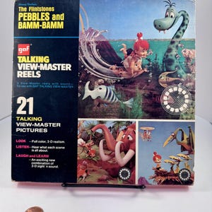 May include: Vintage GAF Talking View-Master Reels set featuring The Flintstones: Pebbles and Bamm-Bamm. The box shows colorful 3-D images of the cartoon characters. The set includes 21 talking pictures and promises full-color, 3-D realism.