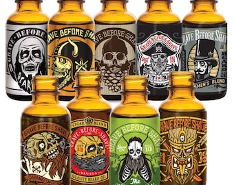 May include: Ten amber glass bottles with labels featuring skull and beard designs. The labels have text that reads "Grave Before Shave" and various scents like "Caramel Mocha Coffee", "Vanilla", and "The Outdoorsman".