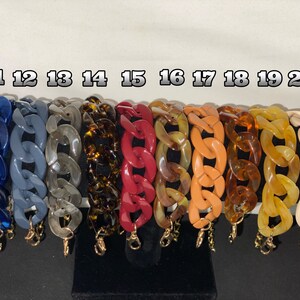 May include: Ten colorful plastic chain bracelets in various colors, including blue, gray, brown, red, orange, yellow, and white. The bracelets are numbered 11 through 20.