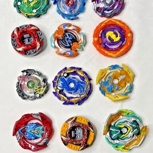 May include: A collection of colorful spinning tops in various designs. The tops feature a variety of colors, including red, blue, green, yellow, and purple. Each top has a unique design with intricate details.