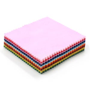 May include: A stack of colorful fabric squares, perfect for quilting or crafting. The top square is a soft pink, with a rainbow of colors visible on the edges, including red, blue, yellow, and green. The edges have a decorative, scalloped design.