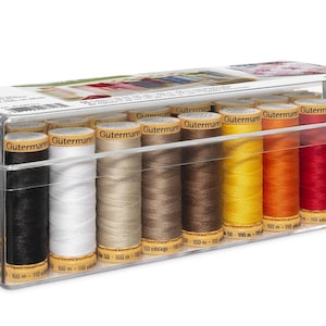 May include: A clear plastic box filled with spools of Gutermann thread in various colors. The thread colors include black, white, beige, brown, yellow, orange, red, and pink. Each spool is labeled with the Gutermann brand name and 100 yds.