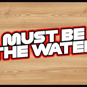 Puede incluir: Texto blanco sobre fondo rojo y negro que dice "Must Be The Water".