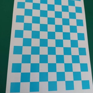 May include: A white sheet of paper with a blue and white checkerboard pattern.