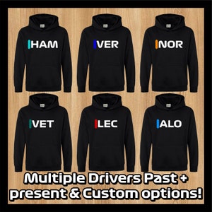 May include: Six black hooded sweatshirts with different coloured stripes and driver names printed on the front. The names are HAM, VER, INOR, VET, LEC, and ALO. The text below the sweatshirts reads "Multiple Drivers Past + present & Custom options!"