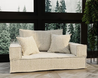 Sofá cama convertible con suelo de espuma y funda extraíble.