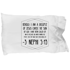 May include: White pillowcase with black text that reads "Behold, I am a disciple of Jesus Christ, the Son of God. I have been called of Him to declare His word among His people, that they might have everlasting life -3 Nephi 5:13"