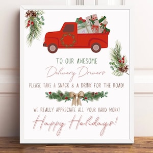 May include: A red truck with a wreath on the front bumper is filled with wrapped gifts. The truck is on a white background with green pine branches and red berries on either side. The text reads: 
