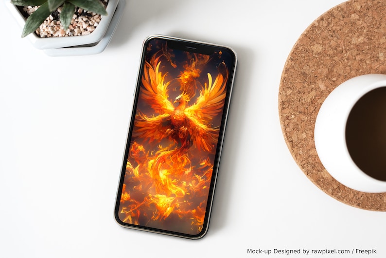 May include: A smartphone displaying a digital illustration of a phoenix rising from flames. The phoenix is depicted in shades of orange and yellow, with its wings spread wide. The background is a dark, smoky color.