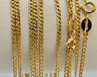 May include: A set of seven gold chains of varying lengths and widths. The chains are made of a delicate, curb link design.