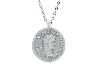 May include: Silver chain necklace with a round pendant featuring a profile of a man's face with the inscription "M.AUREL ANTONINVS PIVS AVG GERM".