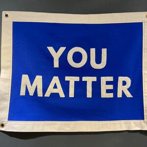 May include: A blue fabric banner with white text that reads "YOU MATTER".