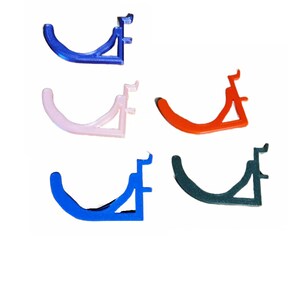 May include: Four 3D printed wall hooks in different colors: blue, pink, orange, and green. Each hook has a curved shape and a triangular base.