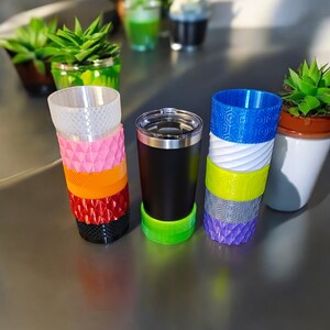May include: A set of six colorful, stackable cups with different patterns. The cups are made of plastic and are perfect for parties or everyday use.