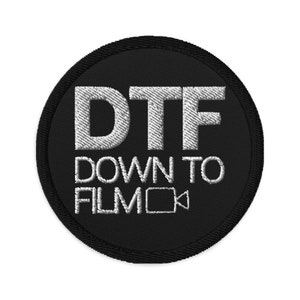 May include: A black and white embroidered patch with the text "DTF Down To Film" and a video camera icon.