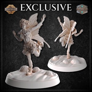 May include: A light-colored miniature figurine of a fairy with textured wings and leaf-patterned clothing, standing on a round base decorated with small pumpkin shapes. The word EXCLUSIVE is printed at the top center of the image.