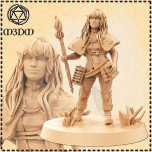 May include: A detailed miniature figurine of an elf woman with long brown hair, wearing a brown leather tunic and holding a staff with a flame-shaped top. She is standing on a round base with grass-like details.