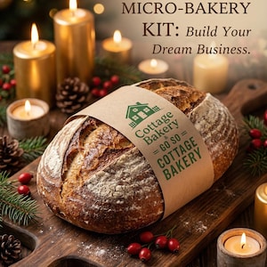 May include: A loaf of sourdough bread on a wooden cutting board, wrapped with a paper band featuring the text "Cottage Bakery". The image includes lit candles, pinecones, and berries, with text that reads "COMPLETE SOURDOUGH MICRO-BAKERY KIT: Build Your Dream Business."