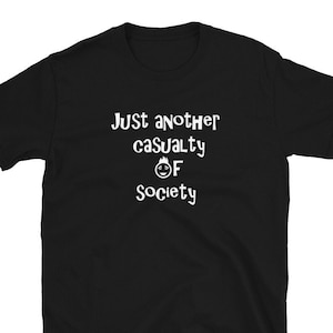 May include: Black t-shirt with white text that reads "Just another casualty of society" with a cartoon face with a flame on top of its head.