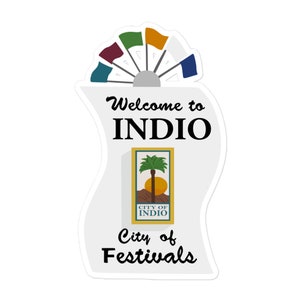 May include: A white sticker with the text "Welcome to INDIO" and "City of Festivals". The sticker features a logo with a palm tree and sun, and a fan of colorful flags.