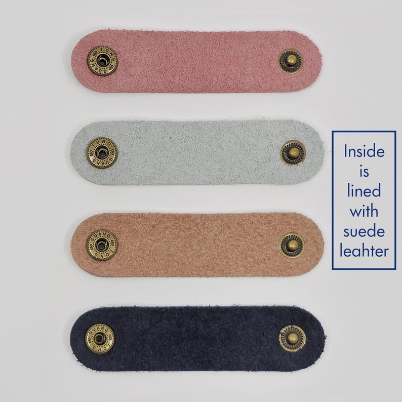 KALLACALLA suede-lined leather cord organizer straps for phone chargers and tech cables, available in multiple soft colors.