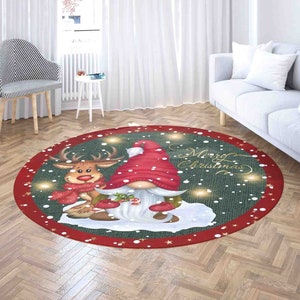 May include: A round Christmas-themed rug with a red border and a green center. The rug features a gnome wearing a red hat and a reindeer with a red scarf. The text "Merry Christmas" is written in gold lettering on the rug.