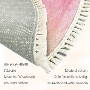 May include: A round, pink and white rug with a white fringe border. The rug is made of cotton and is machine washable. It is available in two sizes: 36x36 inches and 48x48 inches. The rug has an anti-skid bottom and is safe for children.