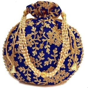 May include: A round, navy blue handbag with gold floral embroidery. The bag features a drawstring closure and is adorned with a beaded handle and tassel accents. The bag is approximately 8 inches in diameter.