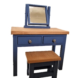 May include: Miniature blue vanity with a wooden top and two drawers, featuring a small mirror and a matching stool. The vanity has decorative knobs and is designed for a dollhouse or similar setting.