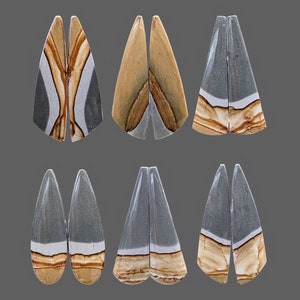 May include: Six pairs of teardrop-shaped cabochons, each pair is a matching set. The cabochons are made of a layered stone with shades of grey, brown, and white.
