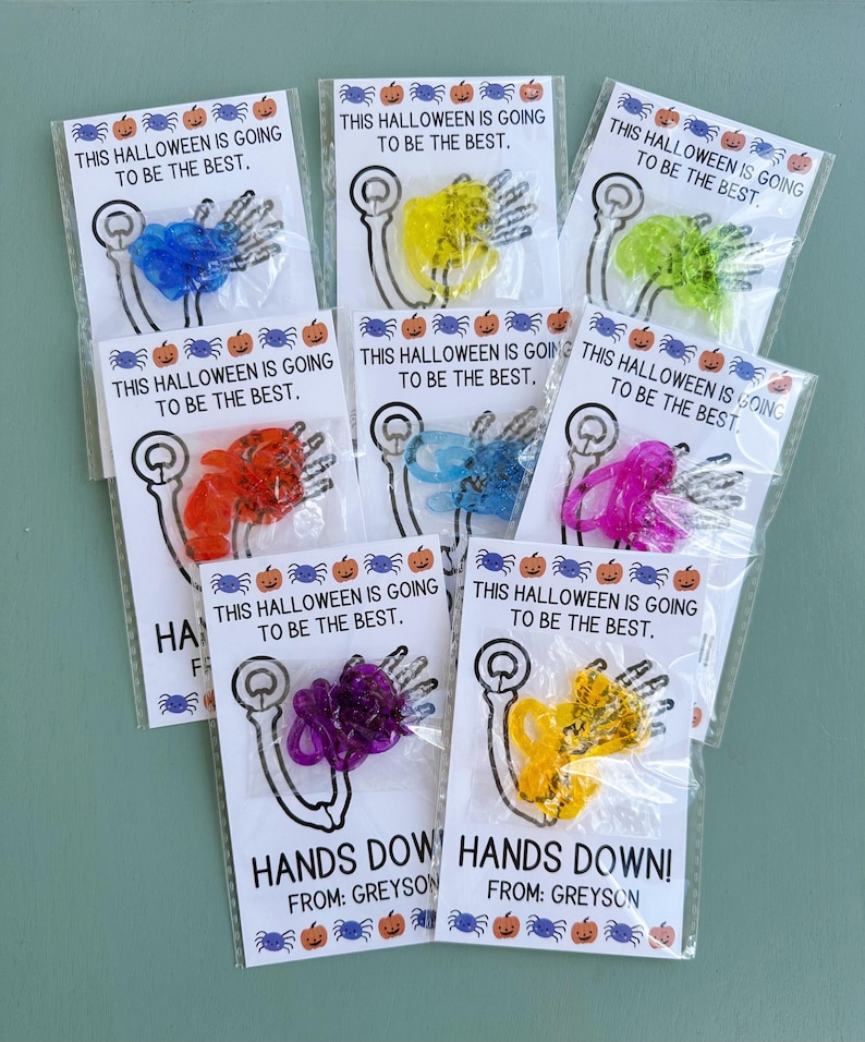 May include: Eight small bags with colorful plastic hands and the text "This Halloween is going to be the best."  Two bags have the text "Hands Down!" and "From: Greyson".