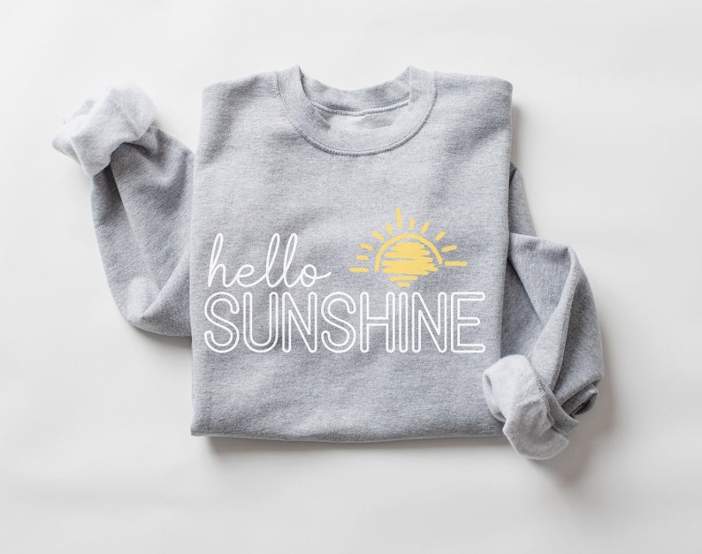 May include: Gray sweatshirt with a white outline of the text "hello sunshine" and a yellow sun graphic.