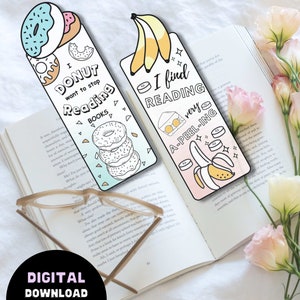 Pode incluir: Dois marcadores coloridos com tema de donut e banana. O marcador de donut diz "Eu n&atilde;o quero parar de ler livros". O marcador de banana diz "Eu acho a leitura muito atraente".