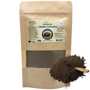 May include: A brown paper bag of Chadian Chebe Powder with a pile of the powder and a small wooden scoop. The bag has a clear window and a label with text and a circular graphic. The bag contains 50g of the product.