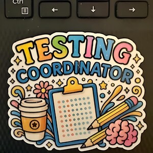 May include: A colorful sticker with the words "TESTING COORDINATOR" in bubble letters. The sticker features a coffee cup, clipboard, pencils, and a brain. The design includes stars, flowers, and swirls.