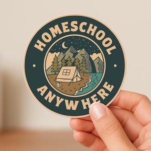 May include: A round sticker with a dark teal border featuring the words "HOMESCHOOL ANYWHERE HERE" in white. The center design shows a tent, mountains, trees, a crescent moon, and a body of water in a nature scene.