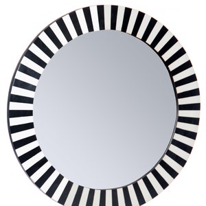 May include: A round mirror with a black and white striped frame. The frame is made of wood and has a polished finish.