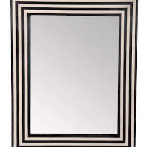 May include: A rectangular mirror with a black and white striped frame. The frame has five stripes, alternating between black and white.