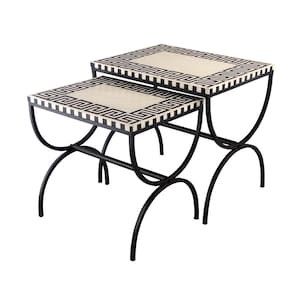 May include: A set of two black metal nesting tables with white and black geometric patterned tops.