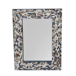 May include: Rectangular mirror with a mosaic tile frame. The frame features a mix of iridescent tiles in shades of silver, blue, brown, and purple. The mirror has a clean, reflective surface, suitable for home decor.