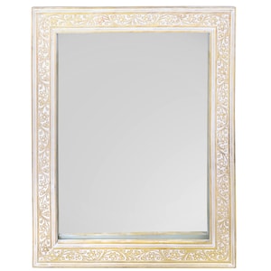 May include: A white wooden mirror frame with a gold floral design. The frame is ornate and has a rectangular shape.