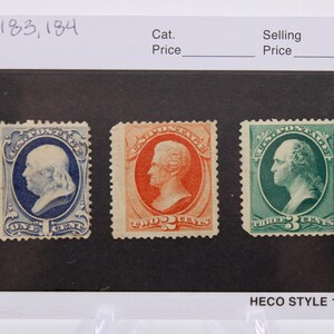 May include: Three United States postage stamps featuring the portraits of Benjamin Franklin, George Washington, and Abraham Lincoln. The stamps are arranged from left to right, with the one-cent stamp featuring Franklin, the two-cent stamp featuring Washington, and the three-cent stamp featuring Lincoln. The stamps are all in the same style, with a blue, red, and green background, respectively. The stamps are all in good condition and are a great addition to any stamp collection.