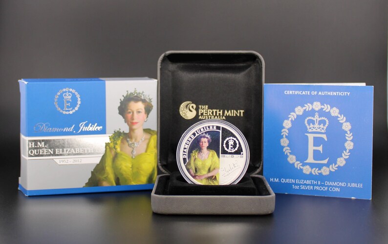 May include: A commemorative coin from The Perth Mint, featuring Queen Elizabeth II, displayed in a presentation box. The coin is in a black case, with a blue box and certificate of authenticity. The coin is for the Diamond Jubilee.