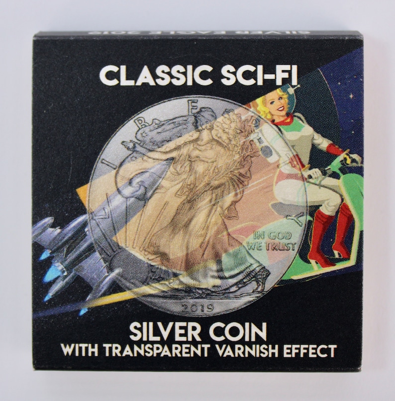 May include: A silver coin with a transparent varnish effect. The coin features a depiction of Lady Liberty and the words "IN GOD WE TRUST" and "2019". The coin is overlaid with a sci-fi image of a woman riding a futuristic motorcycle.