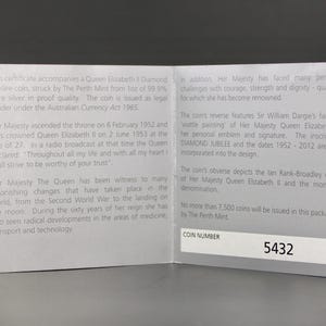 May include: A white ceramic mug with a black handle and the text "But First, Coffee" in a black, bold font. The mug is on a white surface.