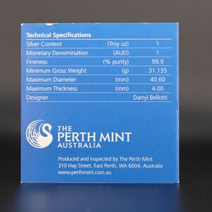 May include: A blue card with technical specifications for a silver product. The card lists details such as silver content, monetary denomination, fineness, minimum gross weight (31.135g), maximum diameter (40.60mm), and maximum thickness (4.00mm). The Perth Mint logo is visible.