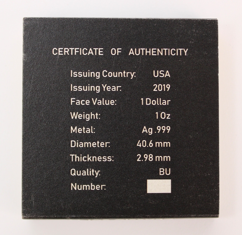 May include: A black certificate of authenticity for a 2019 American Silver Eagle coin. The certificate lists the coin's issuing country, year, face value, weight, metal, diameter, thickness, quality, and number.