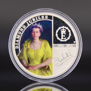 May include: A white ceramic mug with a black handle and the text "But First, Coffee" in a bold, black font. The mug is set against a blurred background, suggesting a cozy setting.